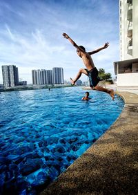 Full length of man jumping in water