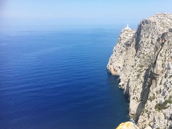 High angle view of rock formation in sea against sky