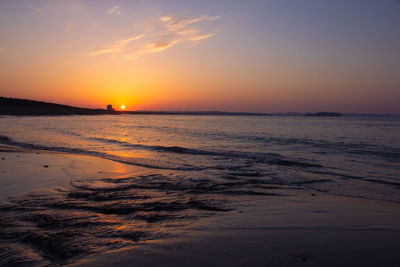 Scenic view of sea against romantic sky at sunset