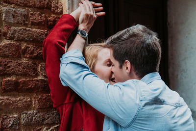 Portrait of man and woman against wall