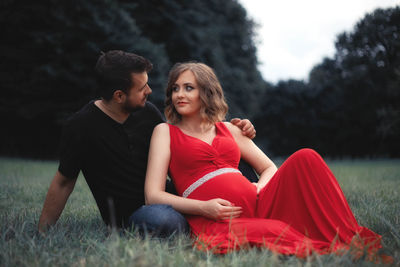 Young couple sitting on field