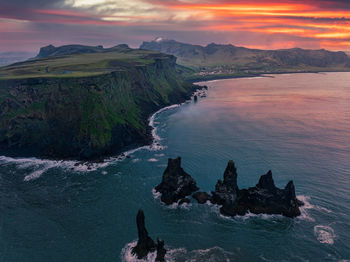 Iceland black sand beach with huge waves at reynisfjara vik.