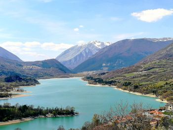 Scenic view of lake and mountains against sky