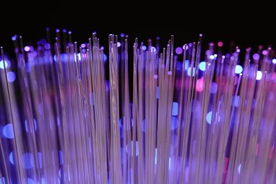 Close-up of illuminated lighting equipment against black background