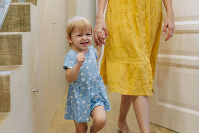 Full length of cute girl standing at home