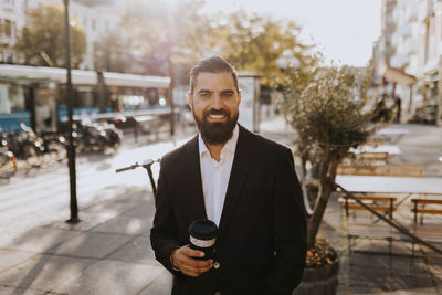 Smiling businessman looking at camera