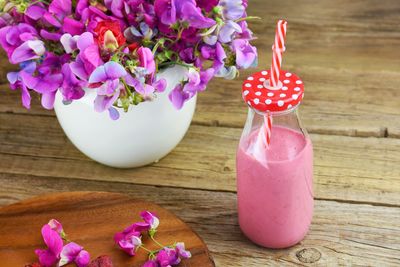 Drink and flowers on table