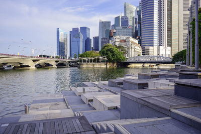 View of swimming pool by buildings in city against sky