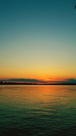 Scenic view of sea against clear sky during sunset