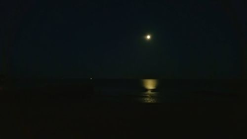 Scenic view of lake against sky at night