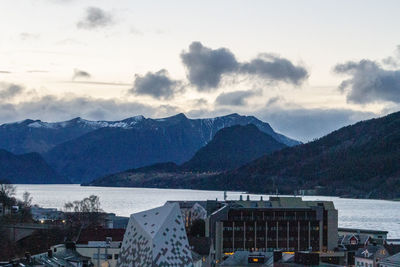 High angle view of townscape by mountains against sky