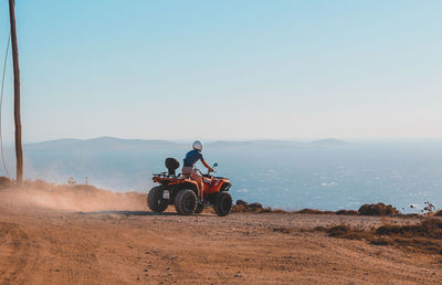 People riding motorcycle on desert