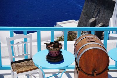 High angle view of chairs and table by sea