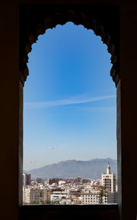 Buildings in city seen through window