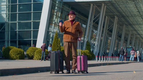 Full length of man standing with luggage