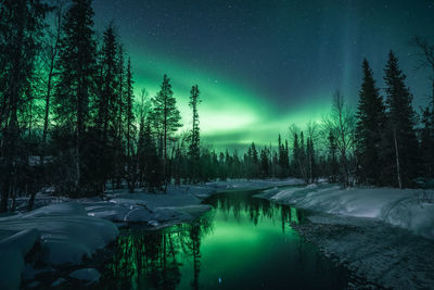 Scenic view of lake against sky at night