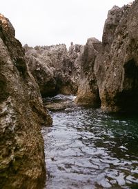 Scenic view of river amidst rocks against clear sky