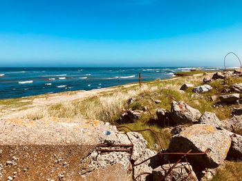Scenic view of beach against blue sky