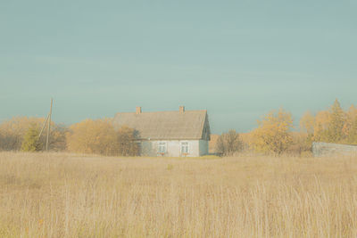 Houses on field against sky