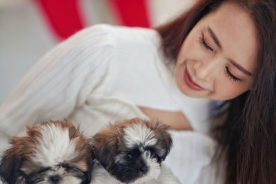 Portrait of woman with dog at home