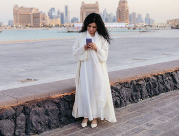 Portrait of young woman using smartphone 