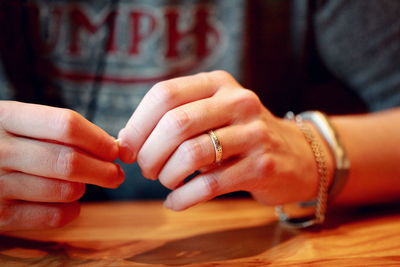 Midsection of woman at table