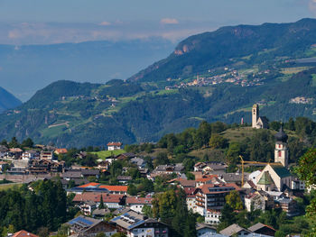 Townscape by mountains against sky