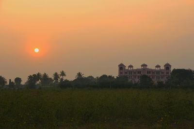 Scenic view of field against sky during sunset