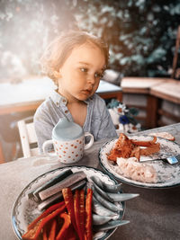 Boy holding ice cream sitting on plate