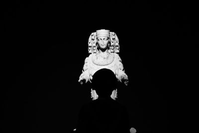 Low angle view of statue against black background