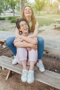Portrait of young woman sitting on bench