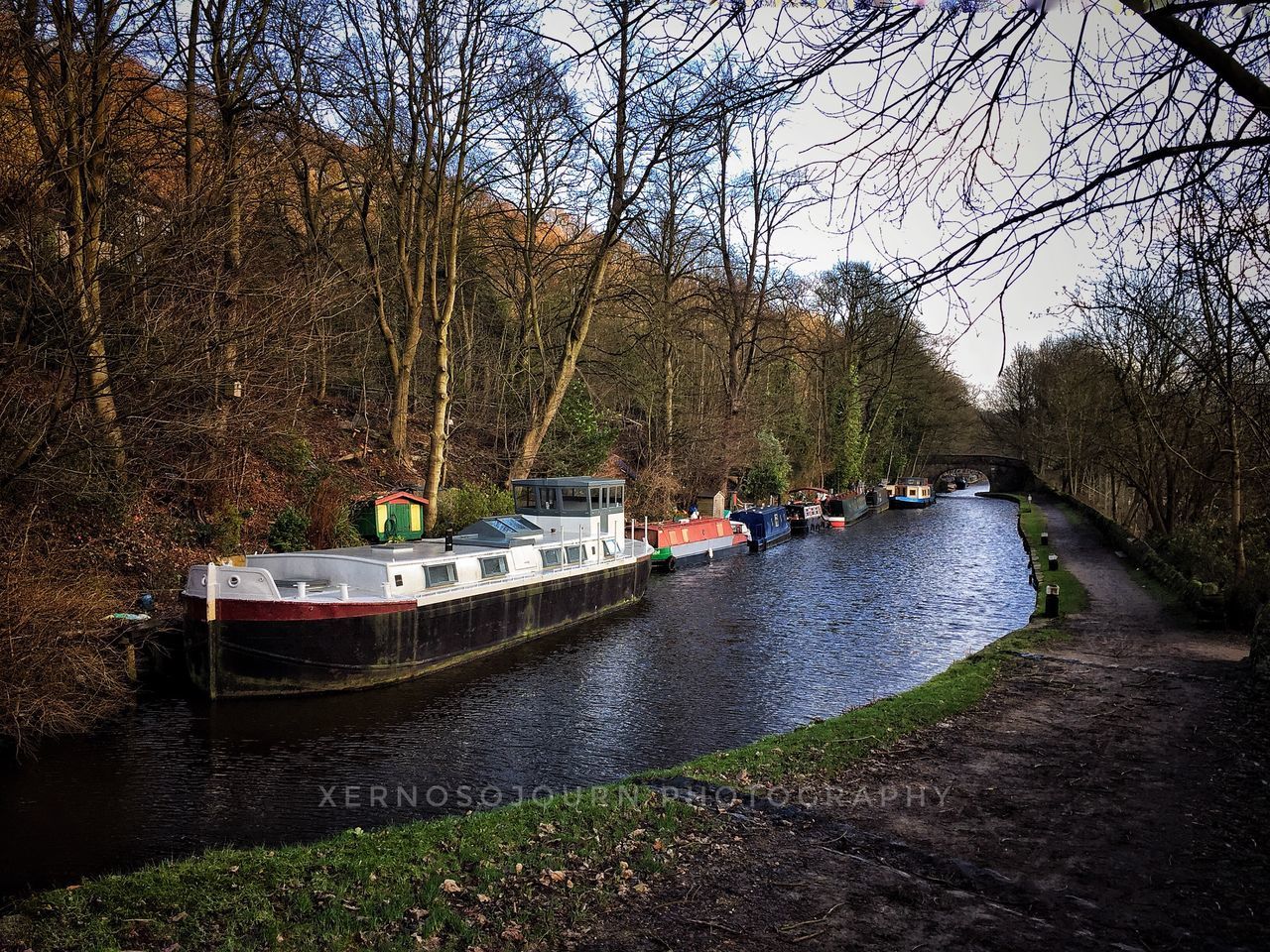 nautical vessel, water, transportation, mode of transport, river, tree, nature, day, no people, outdoors, beauty in nature, ferry, barge, scenics, sky, tourboat, bridge - man made structure