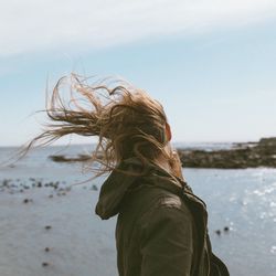 Waving hairs of woman by beach