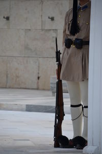 Rear view of woman holding gun