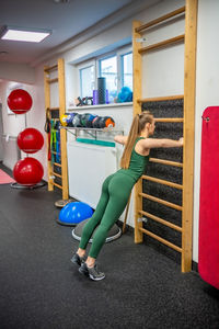 Low section of woman exercising in gym