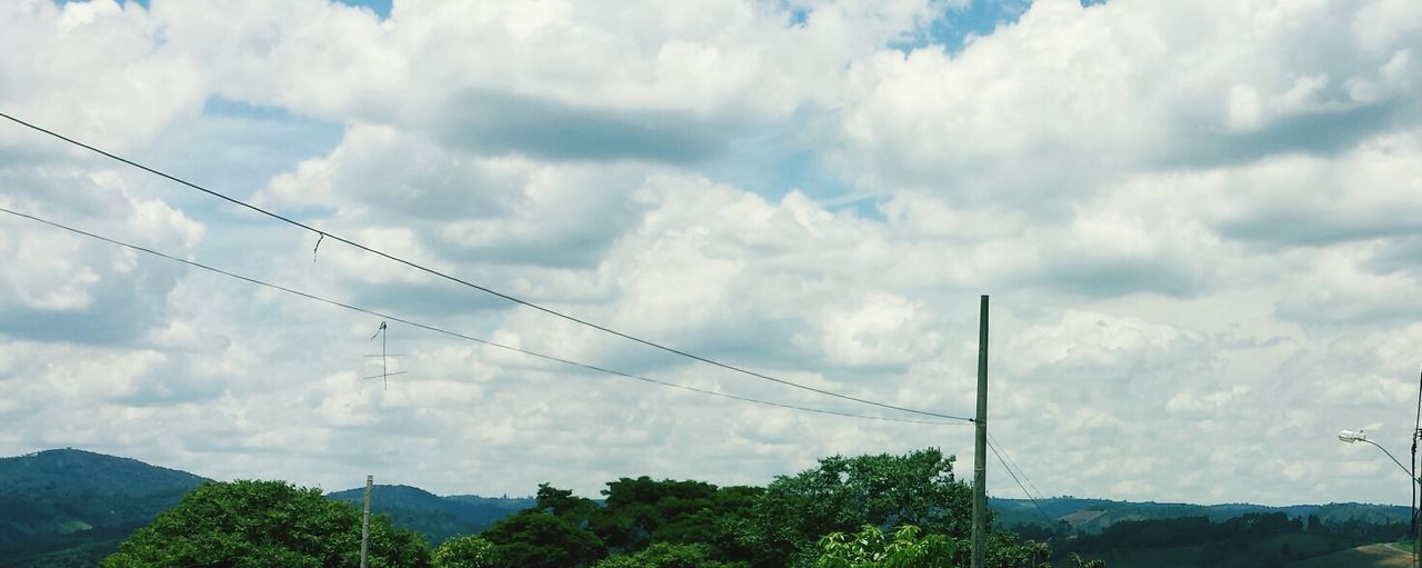 sky, power line, connection, cloud - sky, electricity pylon, electricity, cloudy, cable, power supply, low angle view, mountain, fuel and power generation, cloud, tranquility, tranquil scene, nature, tree, scenics, technology, landscape