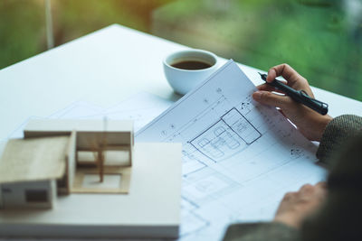 Midsection of businessman working on table