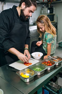Side view of man preparing food at home
