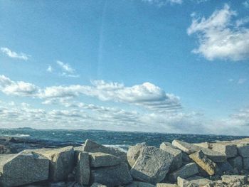 Scenic view of sea against cloudy sky