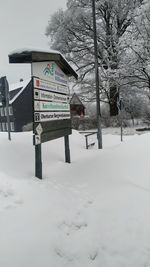 Road sign on snow covered field