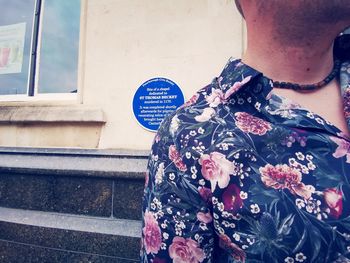 Rear view of man holding text on red wall