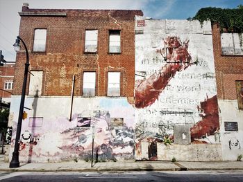 Graffiti on wall by building in city