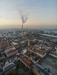 High angle view of smoke emitting from city against sky