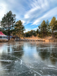 Scenic view of lake against sky during winter