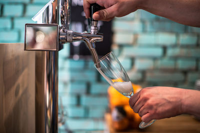 Cropped hand pouring alcohol in glass