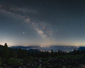 The milky way shining in the night sky above lake tahoe near crystal bay, california.