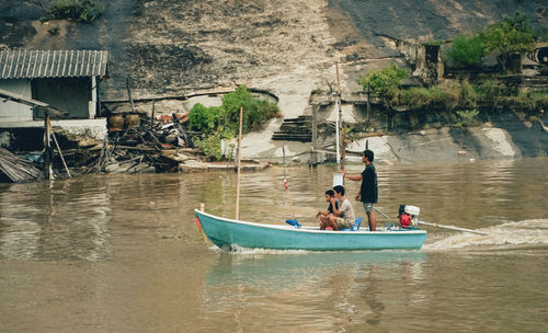 People sitting on boat in river