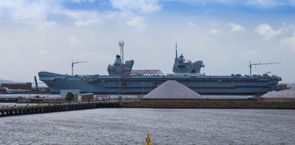 Commercial dock by sea against sky