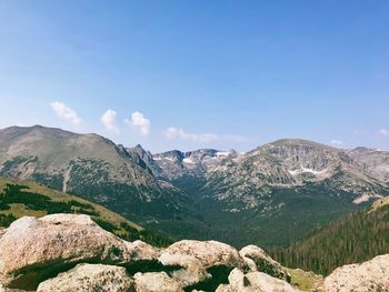 Scenic view of mountains against blue sky