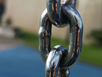 Close-up of chain hanging on metal